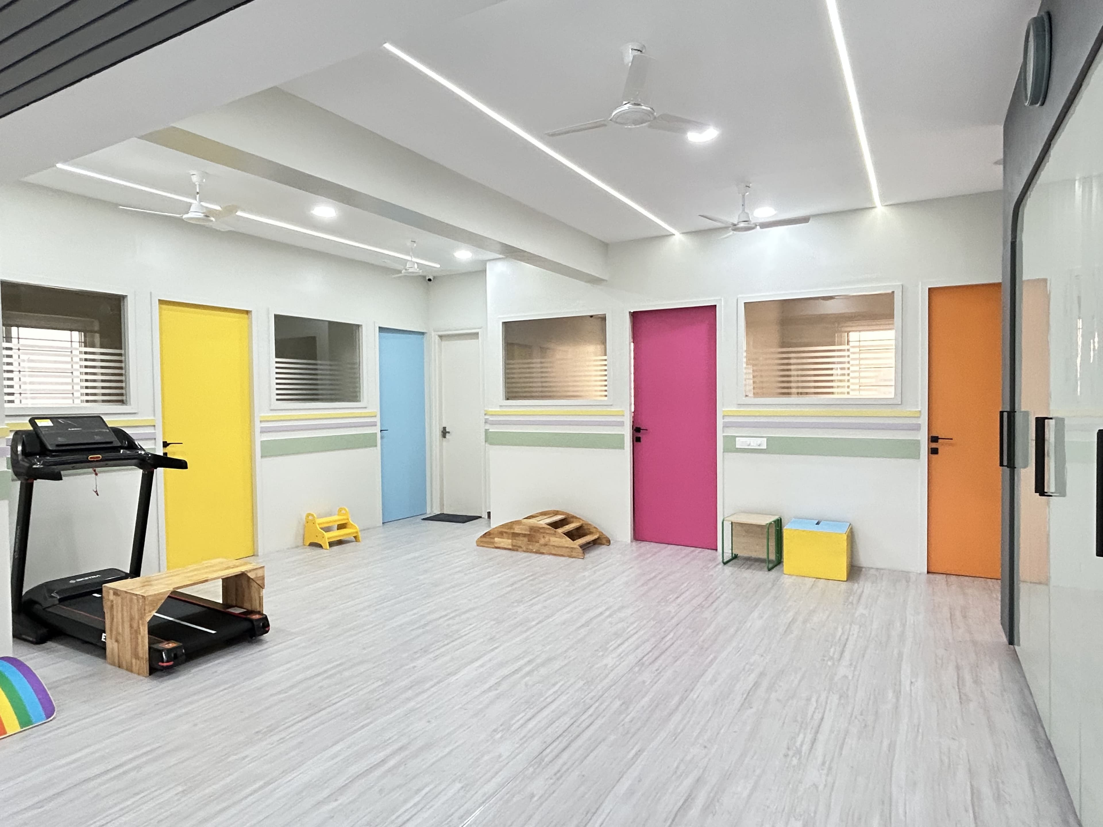 Main therapy hall with colourful doors and equipment