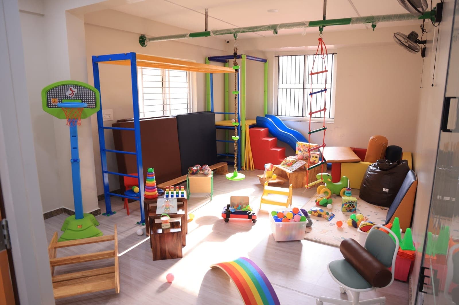 Paediatric sensory gym with climbing frame and colourful toys